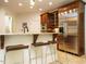 Modern kitchen with granite countertops, stainless steel appliances, and breakfast bar seating at 410 Mountain Laurel, Chapel Hill, NC 27517