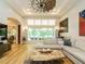 Cozy living room featuring hardwood floors, tray ceilings, and many windows at 410 Mountain Laurel, Chapel Hill, NC 27517