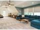 Living area featuring a large blue sofa, vaulted ceilings and neutral decor at 410 Mountain Laurel, Chapel Hill, NC 27517