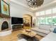 Cozy living room featuring hardwood floors, tray ceilings, and a fireplace at 410 Mountain Laurel, Chapel Hill, NC 27517
