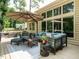Relaxing outdoor patio space featuring comfortable seating, umbrella and natural light from large windows at 410 Mountain Laurel, Chapel Hill, NC 27517