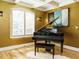 Cozy music room featuring a grand piano, plantation shutters, and stylish decor at 410 Mountain Laurel, Chapel Hill, NC 27517