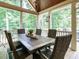 Screened-in porch with dining table, perfect for enjoying meals outdoors at 410 Mountain Laurel, Chapel Hill, NC 27517