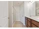 Well-lit bathroom featuring a shower, sink with cabinets, and a toilet at 44 Bordeaux Dr, Clayton, NC 27527
