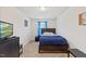 Cozy bedroom with a comfortable bed, a window with blue curtains, and essential furnishings at 44 Bordeaux Dr, Clayton, NC 27527