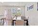 Cozy dining area with modern decor, plenty of natural light, and a view of the backyard at 44 Bordeaux Dr, Clayton, NC 27527