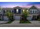 Townhomes with attached garages at dusk, highlighting curb appeal at 44 Bordeaux Dr, Clayton, NC 27527