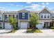Attractive townhomes with garages and manicured lawns under a partly cloudy sky at 44 Bordeaux Dr, Clayton, NC 27527