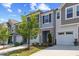Townhome exterior with neat landscaping, stone accents, and attached garages at 44 Bordeaux Dr, Clayton, NC 27527