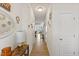 Bright hallway featuring wood floors and decorative wall art at 44 Bordeaux Dr, Clayton, NC 27527