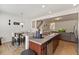 Open kitchen design with granite countertops and breakfast bar that leads to the living area at 44 Bordeaux Dr, Clayton, NC 27527