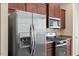 Close up of the kitchen with stainless steel appliances and dark brown cabinetry at 44 Bordeaux Dr, Clayton, NC 27527