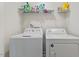 Laundry room with white washer and dryer, and storage shelf above at 44 Bordeaux Dr, Clayton, NC 27527