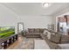 Spacious living room with a large sectional sofa, wooden floors, and a stylish entertainment area at 44 Bordeaux Dr, Clayton, NC 27527