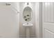 Small powder room with a pedestal sink and decorative mirror at 44 Bordeaux Dr, Clayton, NC 27527