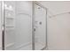 Modern bathroom shower featuring a glass door, chrome fixtures, and built-in shelving at 44 Bordeaux Dr, Clayton, NC 27527