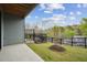 Backyard featuring a concrete patio, black iron fencing, and green landscape, perfect for outdoor enjoyment at 4502 Mint Leaf Lane Ln, Raleigh, NC 27612