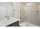 Modern bathroom featuring glass enclosed shower, sleek vanity and light tile walls at 4502 Mint Leaf Lane Ln, Raleigh, NC 27612
