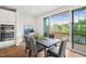 A dining area with dark wood table next to sliding doors leading to a balcony with a view at 4502 Mint Leaf Lane Ln, Raleigh, NC 27612
