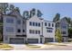 View of the front exterior of the homes showcasing multiple garage doors and modern architecture at 4502 Mint Leaf Lane Ln, Raleigh, NC 27612