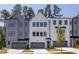 View of the front exterior of the home showing the garage doors and modern architectural style at 4502 Mint Leaf Lane Ln, Raleigh, NC 27612