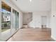 Modern living area with hardwood floors, sliding glass doors, and a staircase at 4502 Mint Leaf Lane Ln, Raleigh, NC 27612