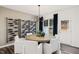 This contemporary dining room showcases designer lighting, a stylish wine rack, and views to the backyard at 5000 Reader Way, Durham, NC 27703