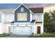 New construction home boasts board and batten siding, a two-car garage, and professionally landscaped front yard at 5000 Reader Way, Durham, NC 27703