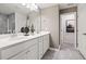 Modern bathroom with double vanity, white cabinets, and a separate tiled shower area at 5010 Reader Way, Durham, NC 27703
