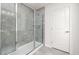 Updated bathroom features a glass-enclosed shower with gray tiling and modern fixtures at 5010 Reader Way, Durham, NC 27703
