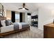 Comfortable bedroom featuring a ceiling fan, windows with dark curtains, and a separate study area at 5010 Reader Way, Durham, NC 27703