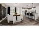 Open floor plan dining room with a round table, wine rack and pendant lighting fixtures at 5010 Reader Way, Durham, NC 27703