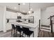 Modern kitchen features a granite island with bar stools, stainless steel appliances and pendant lighting at 5010 Reader Way, Durham, NC 27703