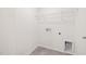 Bright, white laundry room with tile floors and wire shelving for storage at 5010 Reader Way, Durham, NC 27703