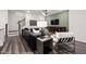 Relaxing living room featuring a sleek leather sofa, mounted TV, and stylish decor at 5010 Reader Way, Durham, NC 27703