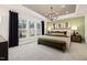 Relaxing main bedroom suite with a tray ceiling, modern chandelier, and plenty of natural light at 5010 Reader Way, Durham, NC 27703