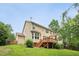 View of backyard featuring a spacious lawn and wooden deck, ideal for outdoor enjoyment at 508 E Hatterleigh Ave, Hillsborough, NC 27278
