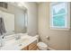 The bathroom contains a sink, toilet, mirror, and a window with wooden blinds at 508 E Hatterleigh Ave, Hillsborough, NC 27278