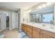 A bright bathroom featuring a double sink vanity with walk-in closet and separate toilet areas at 508 E Hatterleigh Ave, Hillsborough, NC 27278