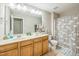 A bathroom featuring a double sink vanity, large mirror, shower, and toilet at 508 E Hatterleigh Ave, Hillsborough, NC 27278