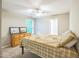 Neutral bedroom with a bed, a ceiling fan, and a light wood dresser under a window at 508 E Hatterleigh Ave, Hillsborough, NC 27278