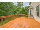 A spacious wooden deck with a grill overlooks a lush green yard, great for outdoor entertaining at 508 E Hatterleigh Ave, Hillsborough, NC 27278