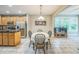 Open dining area adjacent to kitchen with stainless steel appliances and natural light at 508 E Hatterleigh Ave, Hillsborough, NC 27278