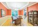 Elegant dining room with hardwood floors, tray ceiling, and natural light at 508 E Hatterleigh Ave, Hillsborough, NC 27278