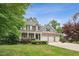 Traditional two-story home with a manicured lawn, three-car garage, and a welcoming front entrance at 508 E Hatterleigh Ave, Hillsborough, NC 27278