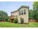 Exterior view of the house featuring a well-maintained lawn and a wooden deck at 508 E Hatterleigh Ave, Hillsborough, NC 27278