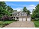 Charming two-story home with stone accents, three-car garage, and well-manicured landscaping at 508 E Hatterleigh Ave, Hillsborough, NC 27278