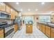Spacious kitchen featuring stainless steel appliances, center island, and tile flooring at 508 E Hatterleigh Ave, Hillsborough, NC 27278