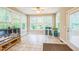 The sunroom has many windows, a reptile enclosure, and tiled flooring at 508 E Hatterleigh Ave, Hillsborough, NC 27278