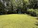 Lush backyard showcasing a small shed surrounded by greenery and mature trees at 509 Forest Ridge Rd, Garner, NC 27529